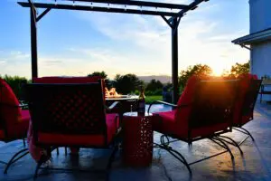 Outdoor seating around a firepit during sunset