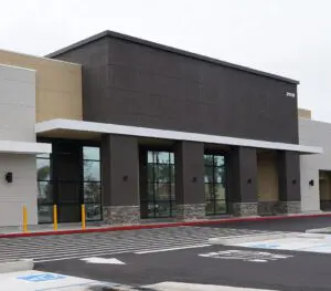 Exterior view of a brown commercial building with a windowed storefront